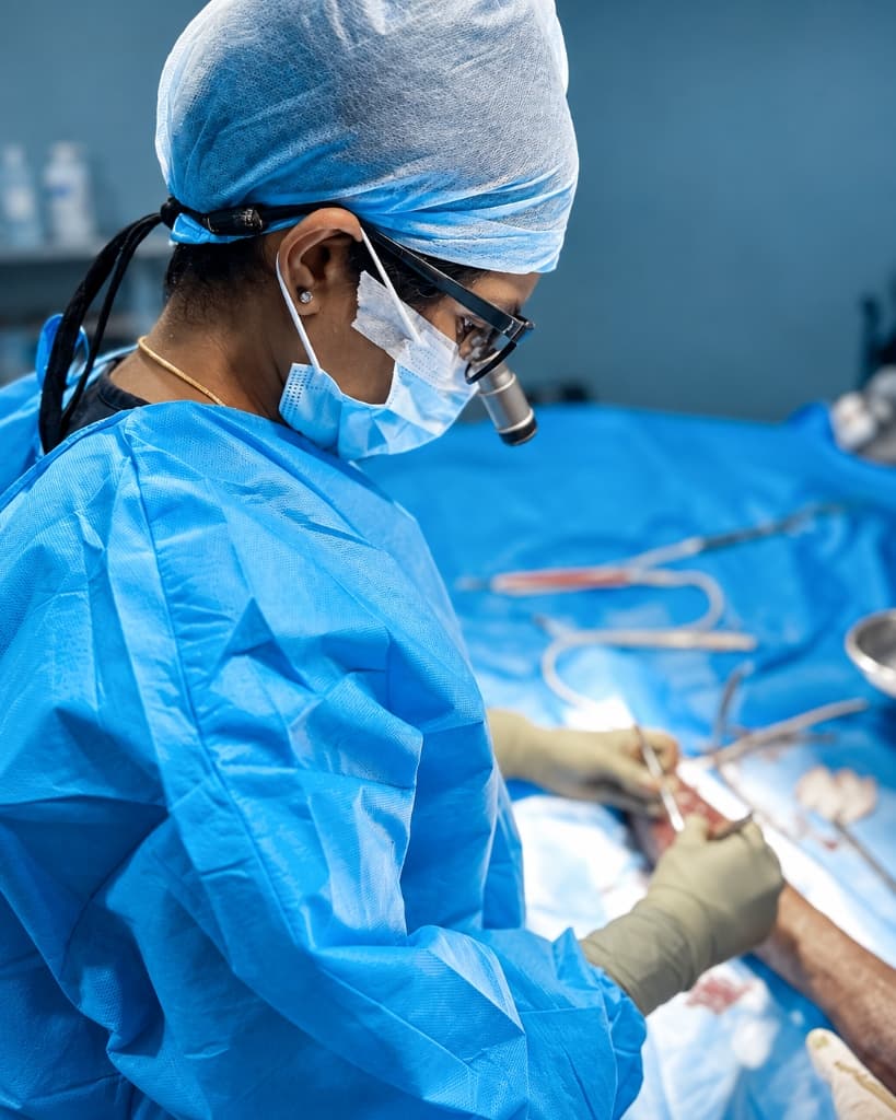 Dr. Nanthini in surgical attire